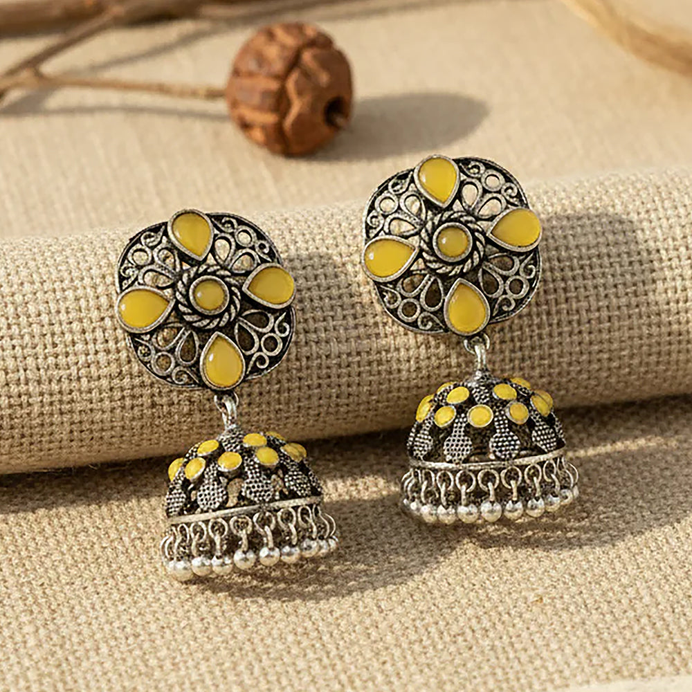 oxidized floral jhumka earrings with yellow stone detailing.