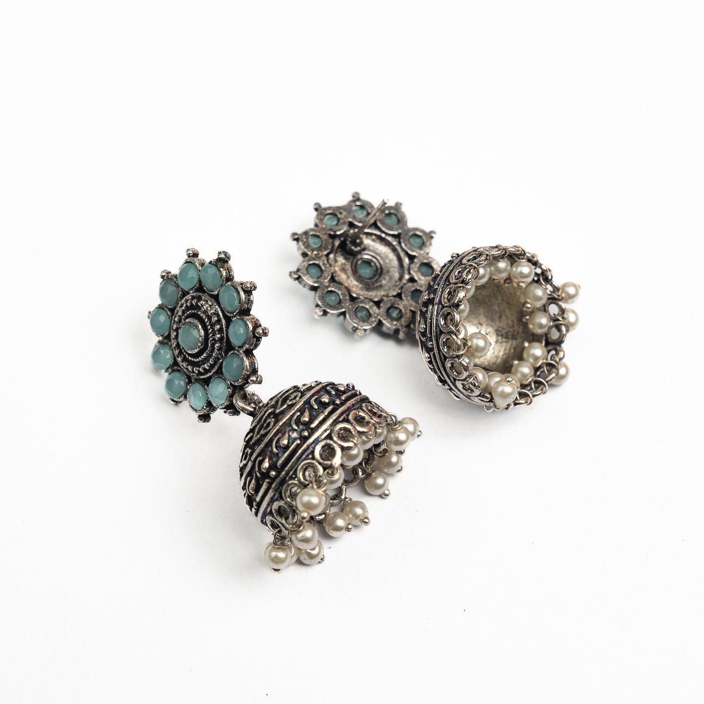 Mint Stone Studded German Silver Jhumki Earrings With Hanging Pearls