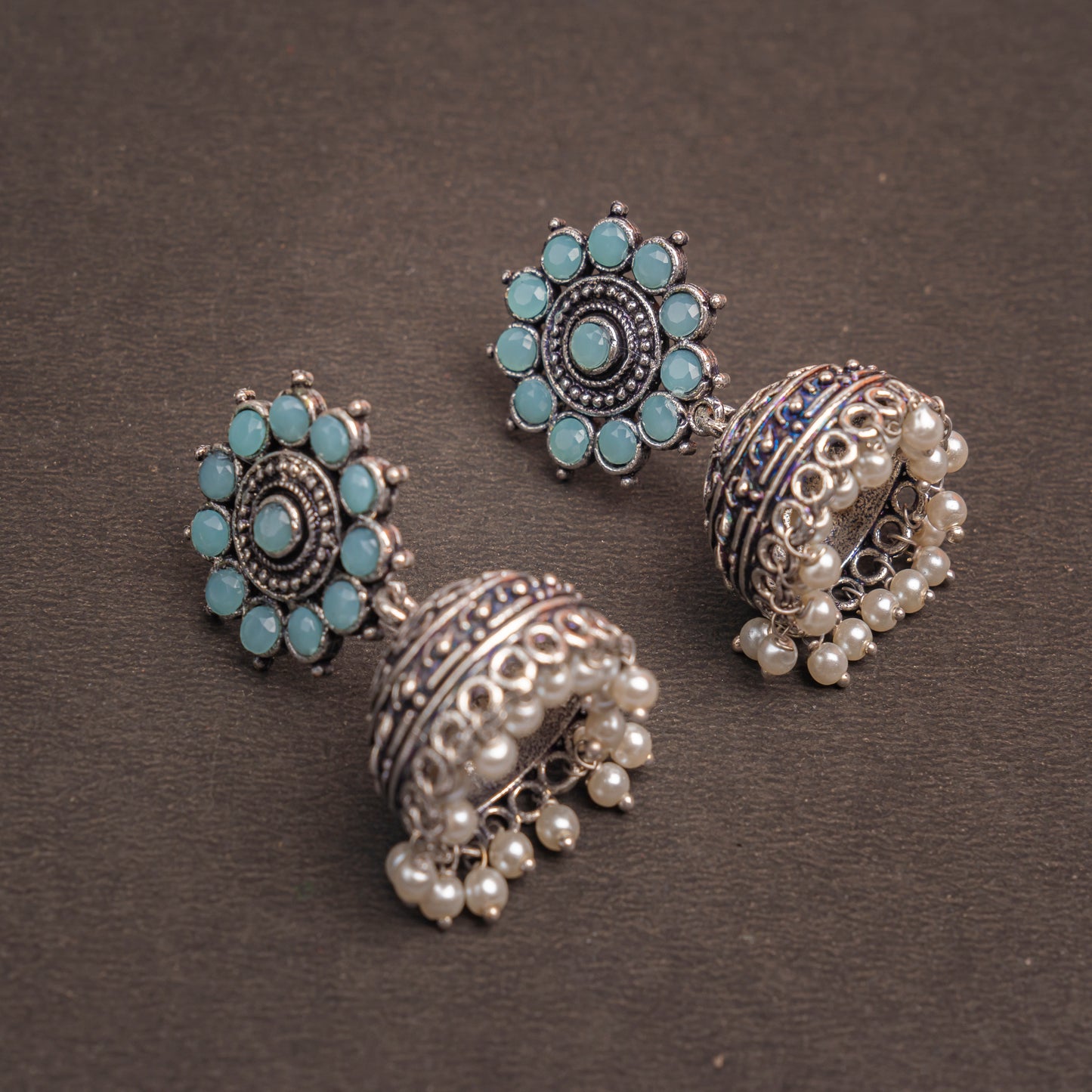 Mint Stone Studded German Silver Jhumki Earrings With Hanging Pearls