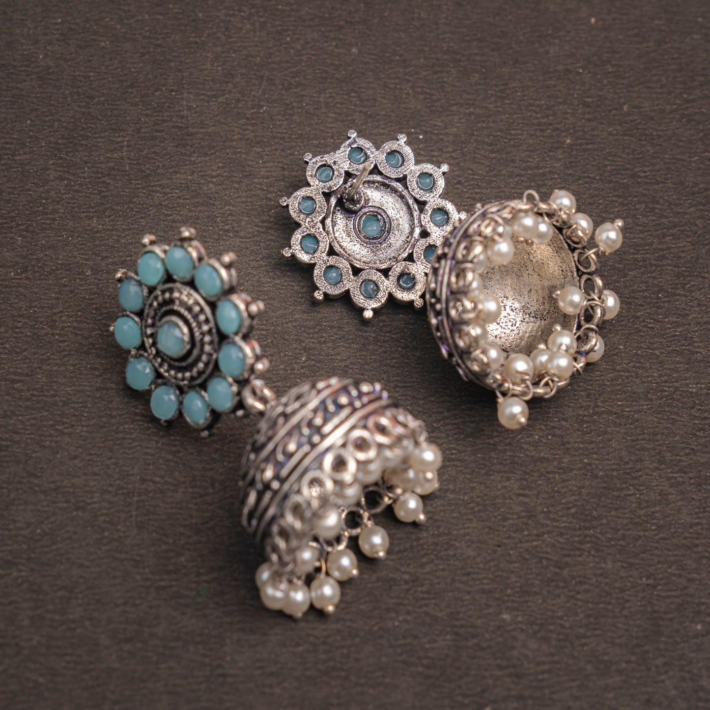 Mint Stone Studded German Silver Jhumki Earrings With Hanging Pearls
