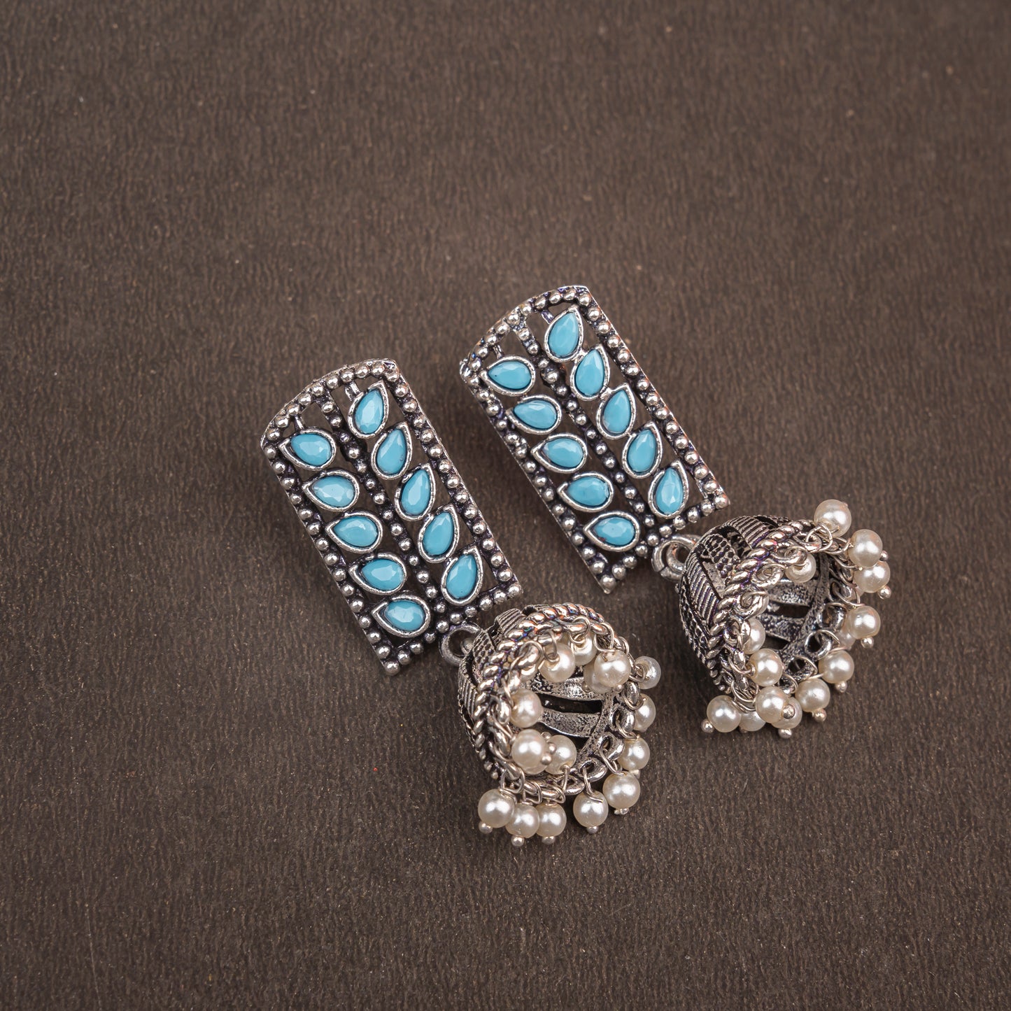 Sky Blue Stone Studded German Silver Statement Earrings With Brass Jhumki