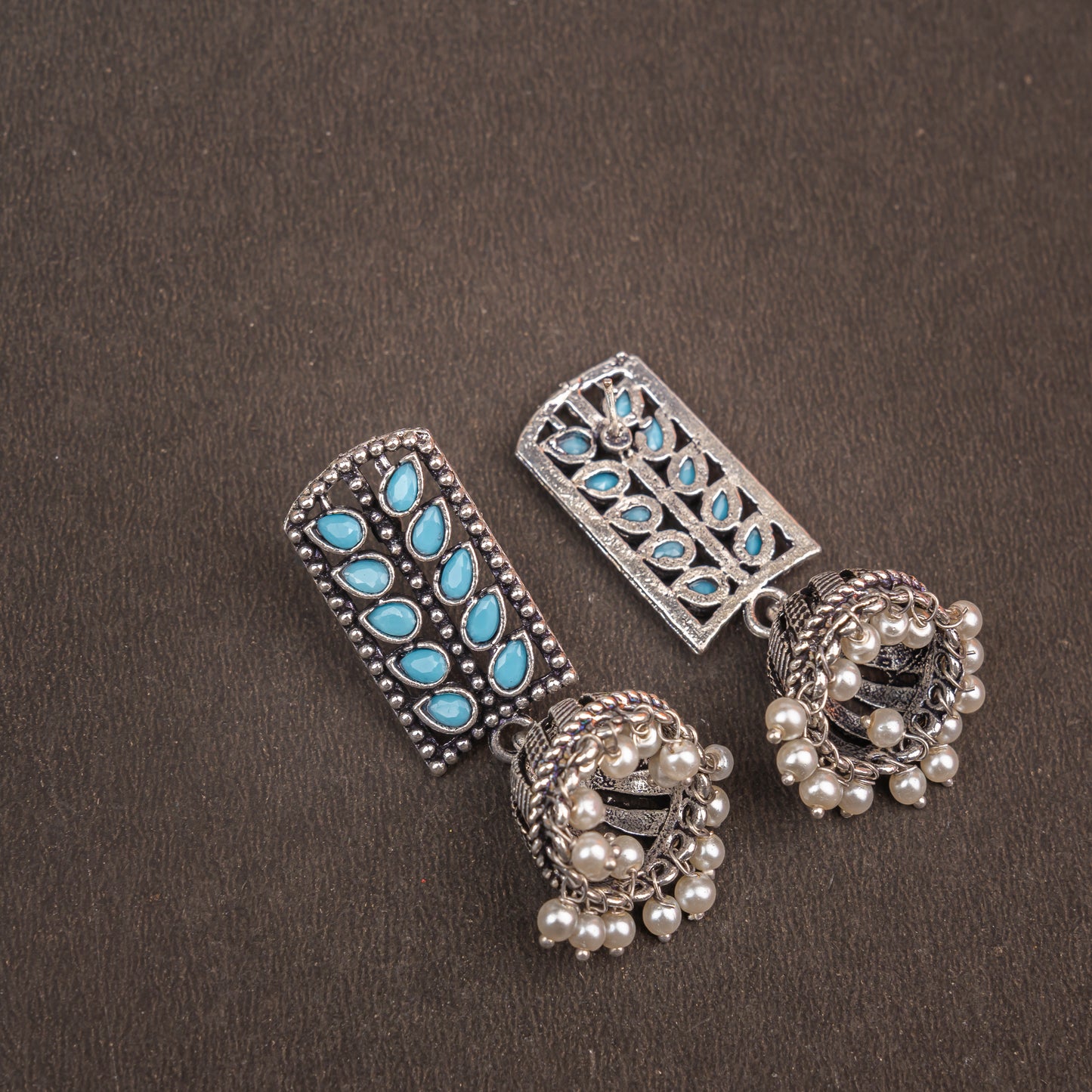 Sky Blue Stone Studded German Silver Statement Earrings With Brass Jhumki