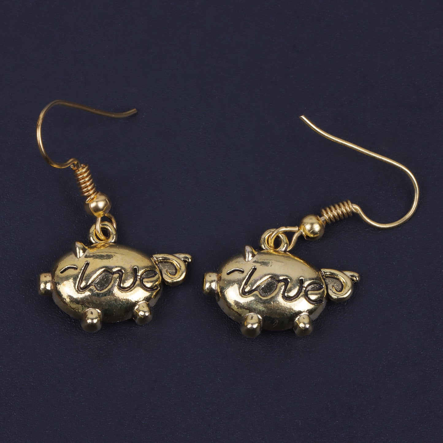 Treasure oink dangler earrings