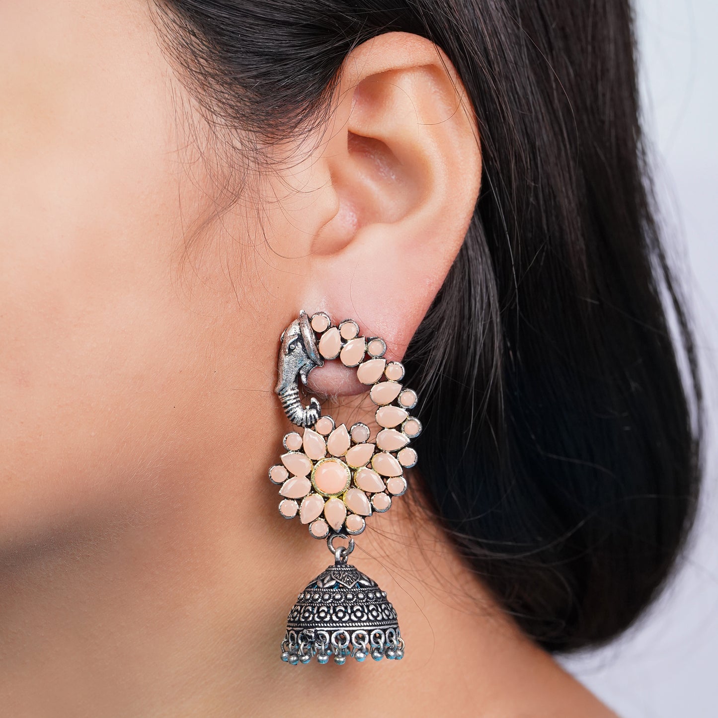 Tusks and twinkle stone studded jhumka earrings (Light Orange)