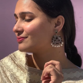 Peacock glow stone studded dangler earrings (Black)