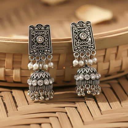 oxidized  jhumka earrings with pearl and white stone detailing.