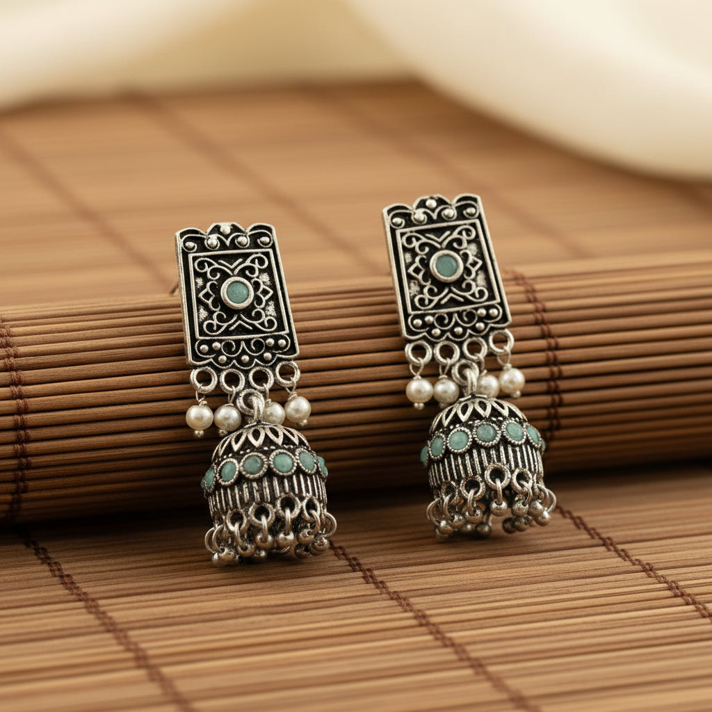 oxidized  jhumka earrings with pearl and mint stone detailing.