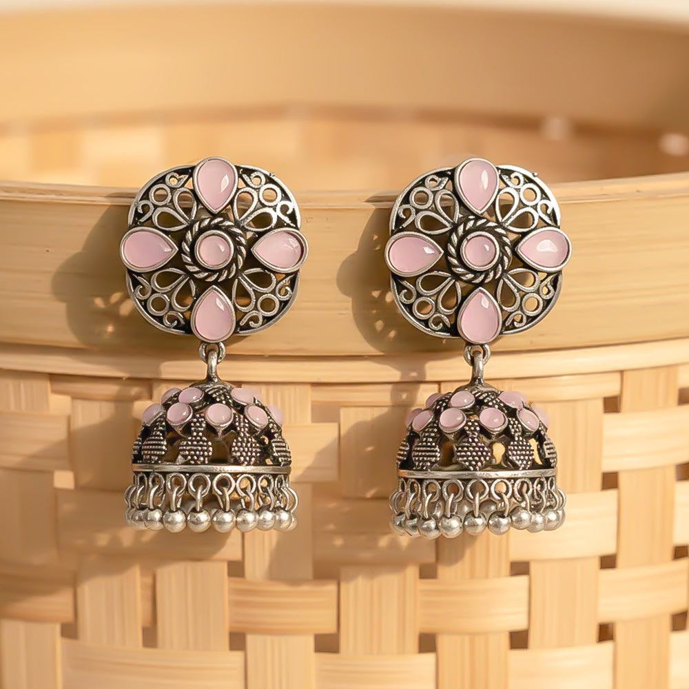 oxidized floral jhumka earrings with baby pink stone detailing.