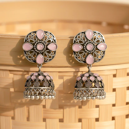 oxidized floral jhumka earrings with baby pink stone detailing.