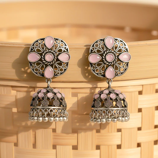 oxidized floral jhumka earrings with baby pink stone detailing.