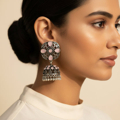 oxidized floral jhumka earrings with baby pink stone detailing.