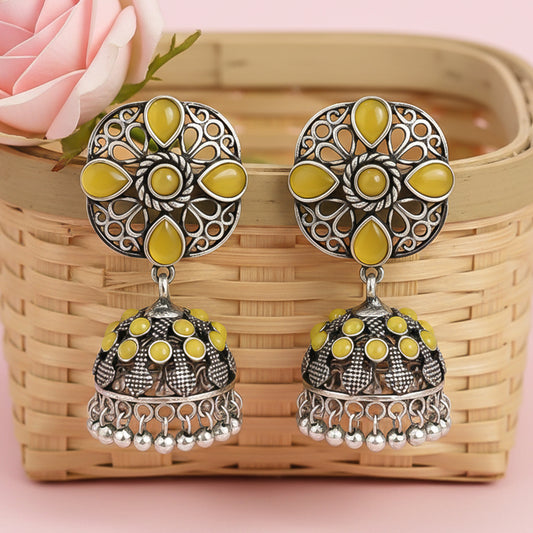 oxidized floral jhumka earrings with yellow stone detailing.