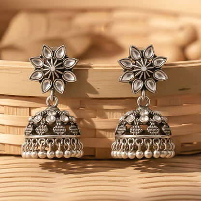 flower-shaped top with petal-like white stones