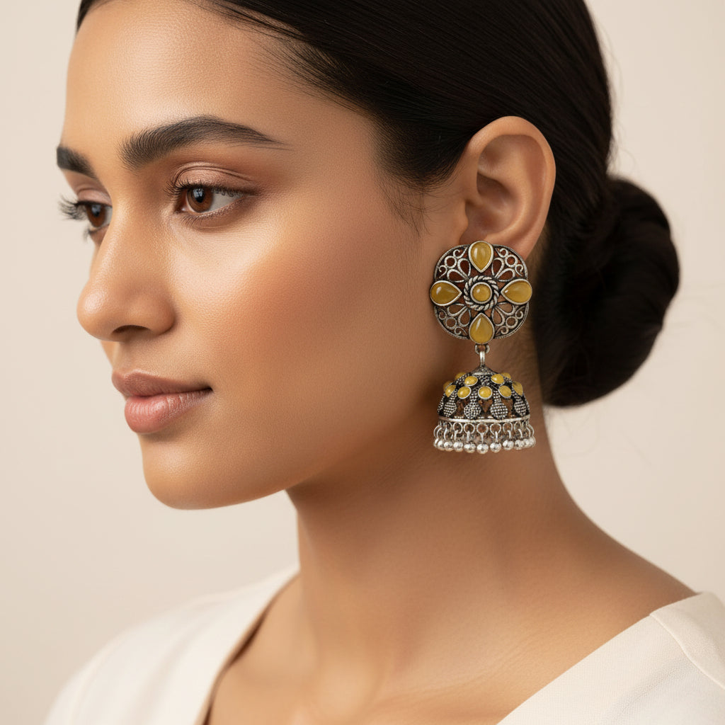 oxidized floral jhumka earrings with yellow stone detailing.