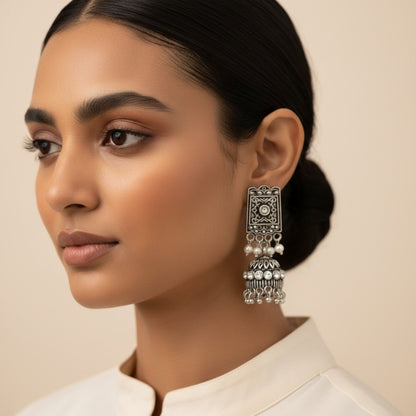 oxidized  jhumka earrings with pearl and white stone detailing.
