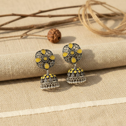 oxidized floral jhumka earrings with yellow stone detailing.