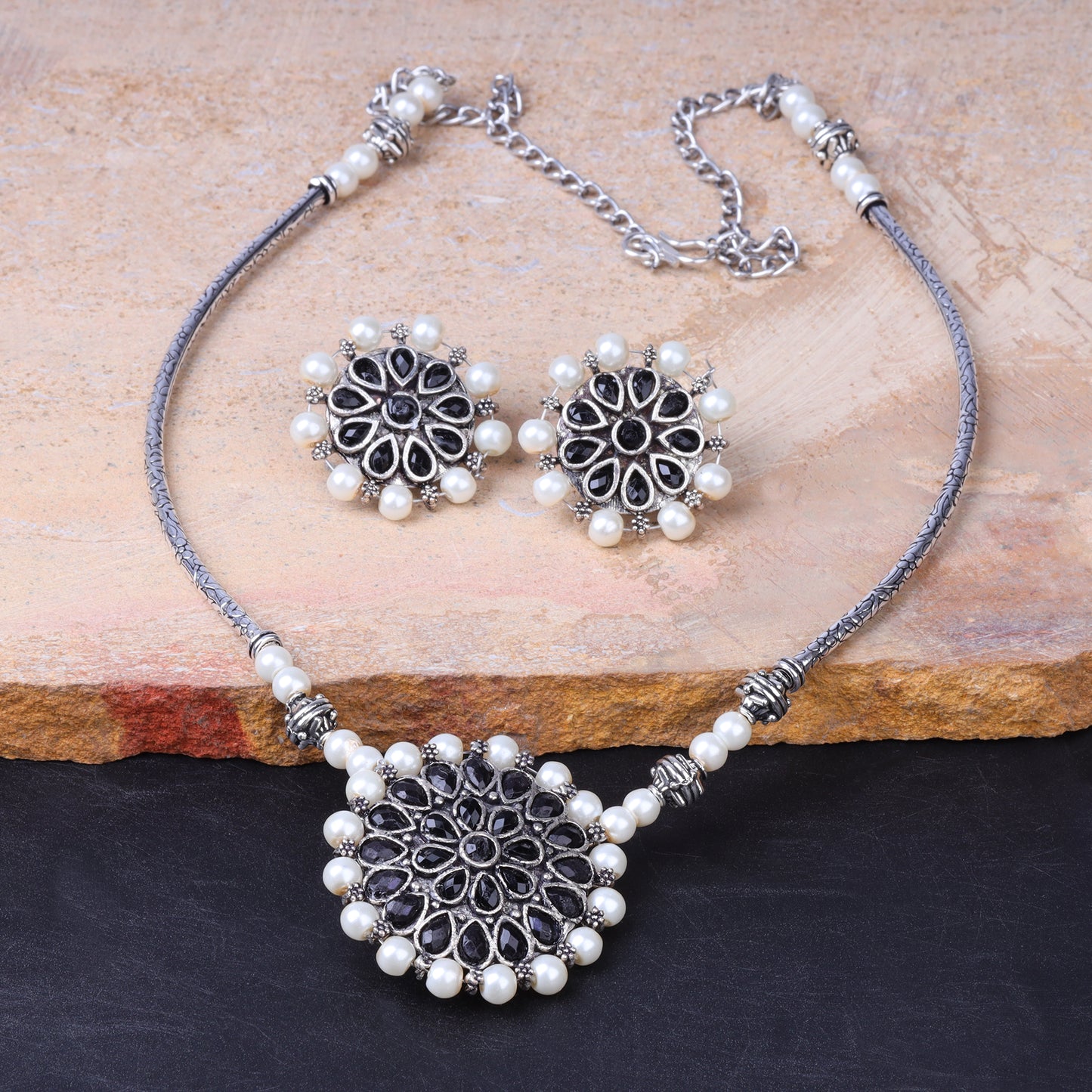 Stylish Brass Piped Neckpiece With Earrings Embellished With Black Stone And Pearls